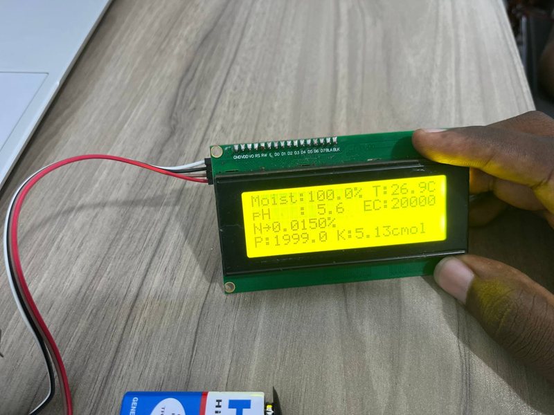 An early SoilPulse prototype screen wired to a circuit board, showing moisture, temperature, pH, EC and nutrient readings
