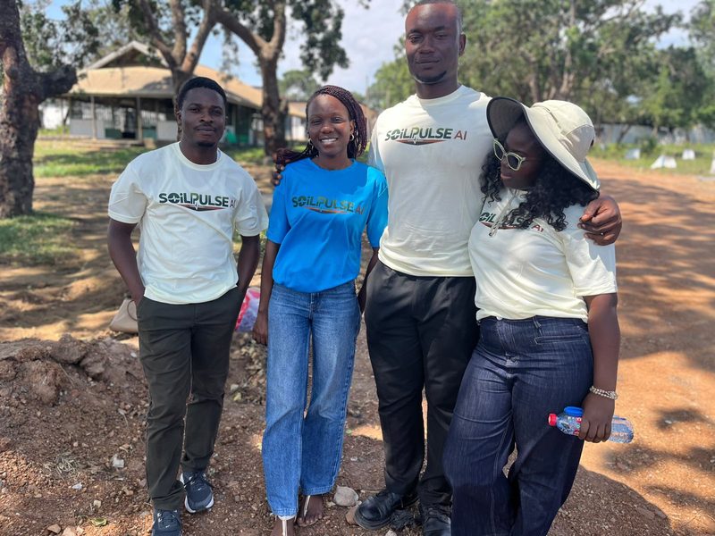 Four members of the SoilPulse AI team standing together outdoors in SoilPulse T-shirts